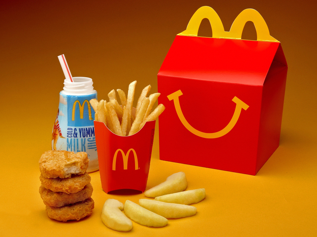 McDonald's cutting down on french fries and adding more healthful items, such as apple slices, to Happy Meals.