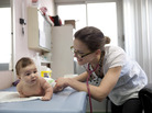 Dr. Sandrine Courtial examines 3.5-month-old Ayline Alhas at the Centre de Protection Maternelle et Infantile (PMI) in Savigny-sur-Orge, France, before giving her a vaccination. Ayline's mother, Melissa, has been bringing her in for free well-child check-ups since her birth. Dr. Sandrine Courtial examines 3.5-month-old Ayline Alhas at the Centre de Protection Maternelle et Infantile (PMI) in Savigny-sur-Orge, France, before giving her a vaccination. Ayline's mother, Melissa, has been bringing her in for free well-child check-ups since her birth.