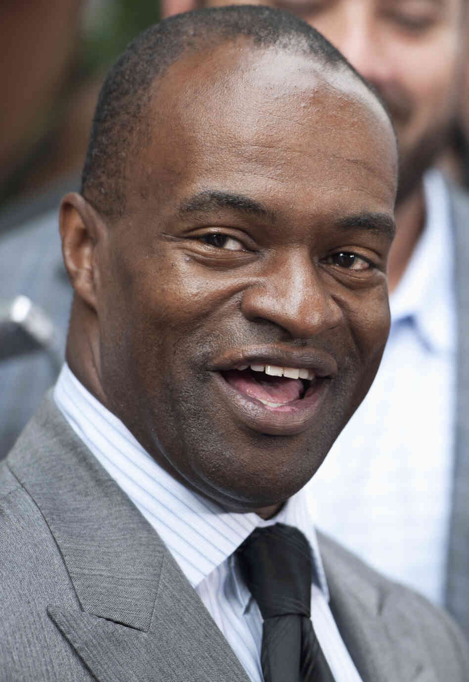 NFLPA Executive Director DeMaurice Smith speaks with reporters outside the NFL Players Association headquarters in Washington, Monday, July 25, 2011, after the NFL Players Association executive board and 32 team reps voted unanimously Monday to approve the terms of a deal with owners to the end the 4½-month lockout.