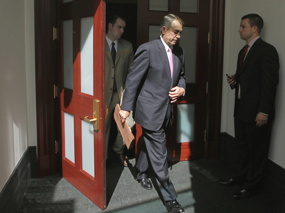 House Speaker  John Boehner of Ohio emerges from a closed-door caucus with House Republicans, July 27, 2011.