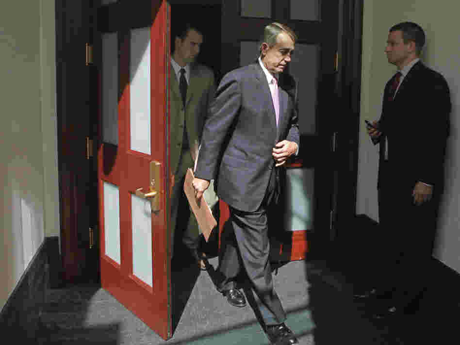 House Speaker  John Boehner of Ohio emerges from a closed-door caucus with House Republicans, July 27, 2011.