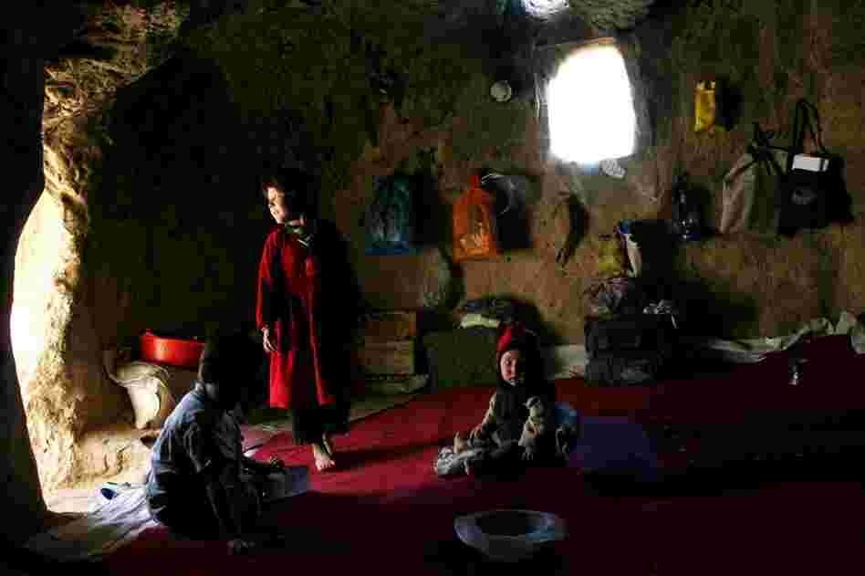 Afghan children living in a small cave near the destroyed Buddha statues, in 2006. Homeless people in the area sometimes move into the caves. They say that new homes are more important than restoring the Buddhas. 