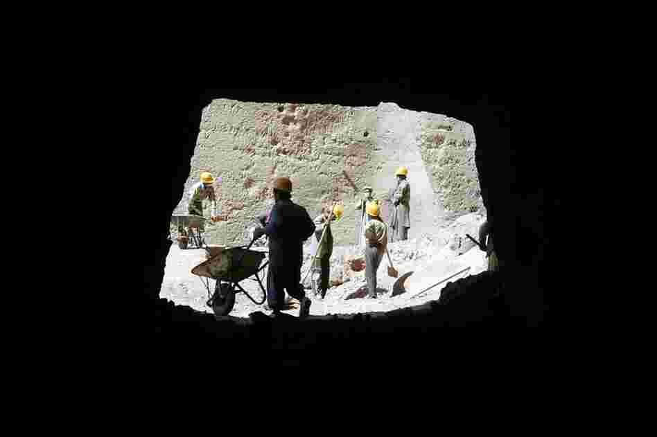 Workers remove pieces of one of the destroyed Buddha statues in September 2005. The United Nations is spearheading the multimillion-dollar restoration project. 