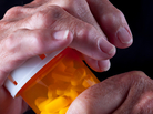 Arthritic senior citizen's hands on a pill bottle. Arthritic senior citizen's hands on a pill bottle.