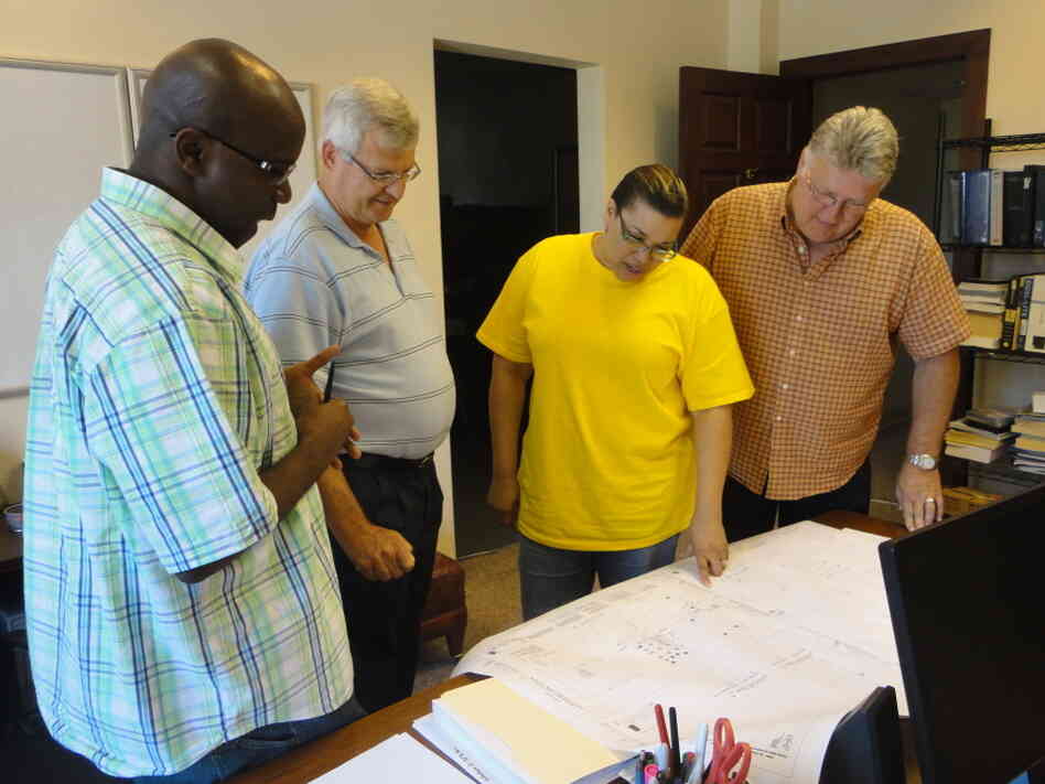 Daphne Wilson (center) and her engineering team review plans for a project at Mitchell International Airport in Milwaukee, Wis.