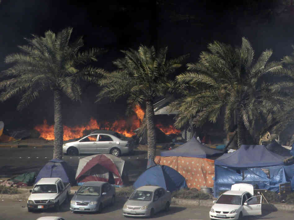 Tents burn on March 16 as Bahraini security troops raid the site of a pro-democracy sit-in at Pearl Square, in the capital, Manama.