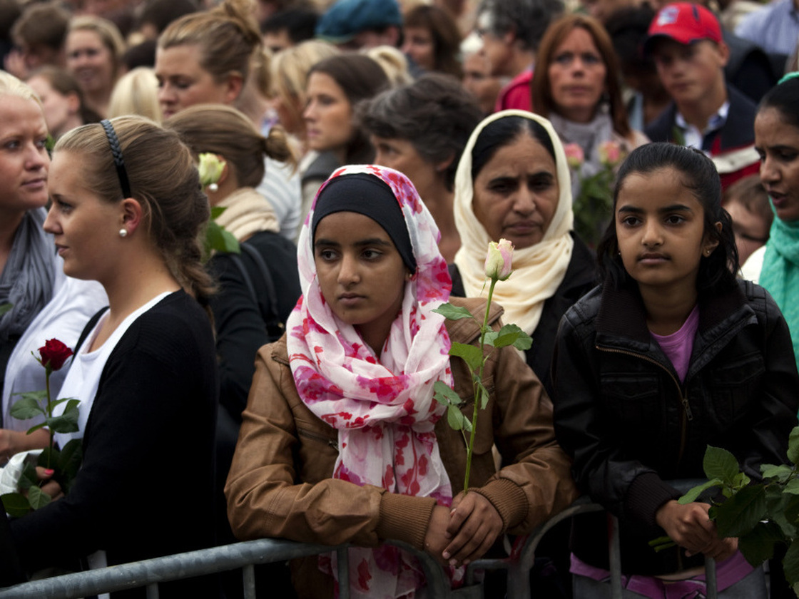 People gather outside Oslo City Hall on Monday to participate in a "rose march" in memory of the victims of Friday's twin attacks in Norway. Anders Behring Breivik, who admitted to the attacks but entered a plea of not guilty, said he wanted to save Europe from Muslim immigration.