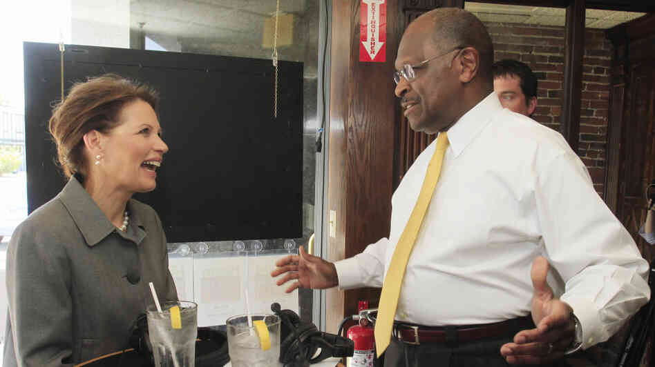 Presidential hopefuls Rep. Michele Bachmann (R-MN), who signed a pledge against abortion rights, and businessman Herman Cain, who has not, seen at the taping of a radio show in New Hampshire in May.