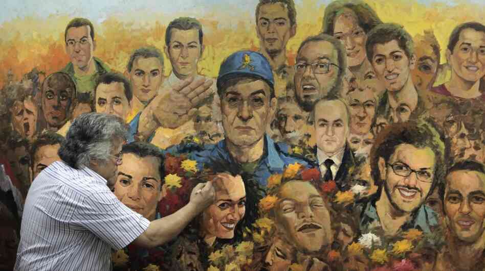 Egyptian artist Taha el Korany finished a painting showing a military officer saluting the "martyrs" of Egypt's revolution at his studio this week — a day after an Egyptian court decided to combine the trials of the former interior minister and ousted President Hosni Mubarak. Egyptian artist Taha el Korany finished a painting showing a military officer saluting the "martyrs" of Egypt's revolution at his studio this week — a day after an Egyptian court decided to combine the trials of the former interior minister and ousted President Hosni Mubarak.
