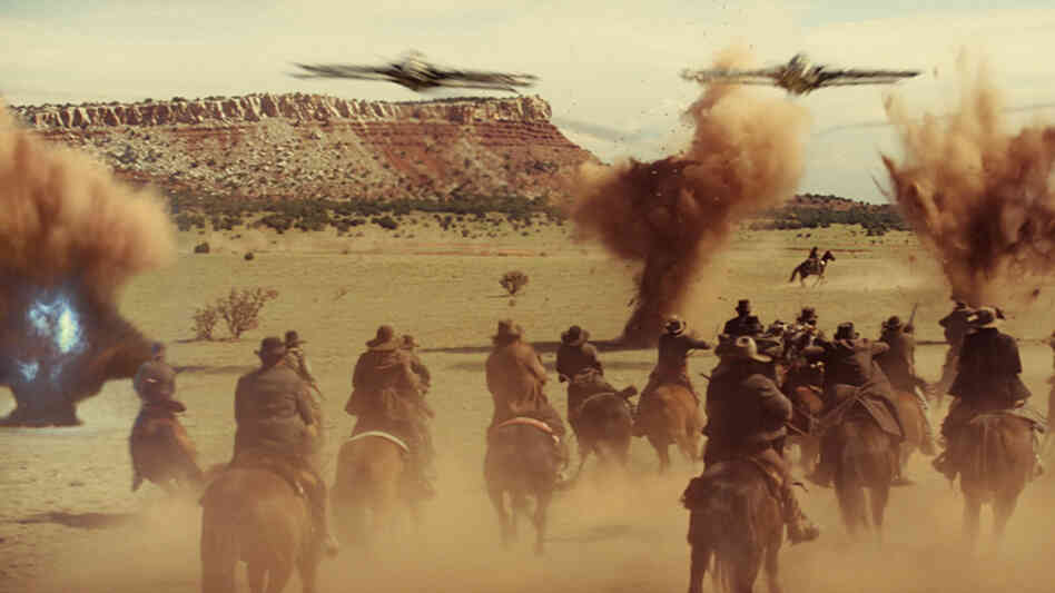 A Western Shootout — With Spaceships: Space invaders take on the Wild West in Jon Favreau's genre-crossing Cowboys & Aliens. A Western Shootout — With Spaceships: Space invaders take on the Wild West in Jon Favreau's genre-crossing Cowboys & Aliens.