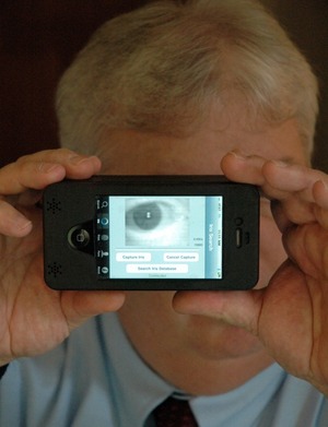 Sean Mullin, CEO of BI2 Technologies, scans his own eye with the MORIS, or Mobile Offender Recognition and Information System. The device attaches to an iPhone and allows police in the field to scan a person's iris, face or fingerprint and then check it against a database to verify his or her identity. Sean Mullin, CEO of BI2 Technologies, scans his own eye with the MORIS, or Mobile Offender Recognition and Information System. The device attaches to an iPhone and allows police in the field to scan a person's iris, face or fingerprint and then check it against a database to verify his or her identity.