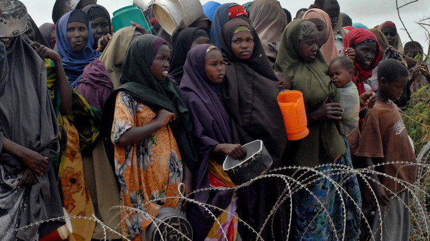 Internally displaced Somalis wait for food at a distribution point at the government-run Badbaado refugee camp in a suburb of the capital Mogadishu on Tuesday. The U.N.'s World Food Programme said its airlift to Mogadishu for drought victims was delayed Tuesday because of last-minute bureaucratic hurdles in Kenya. Internally displaced Somalis wait for food at a distribution point at the government-run Badbaado refugee camp in a suburb of the capital Mogadishu on Tuesday. The U.N.'s World Food Programme said its airlift to Mogadishu for drought victims was delayed Tuesday because of last-minute bureaucratic hurdles in Kenya.
