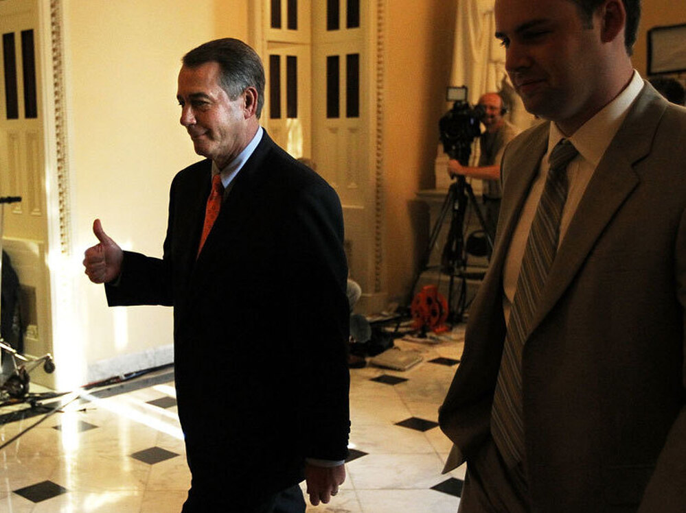 House Speaker John Boehner gives a thumbs up after the chamber passed his plan Friday to raise the debt ceiling and cut spending. The Senate voted to kill the measure a short time later.