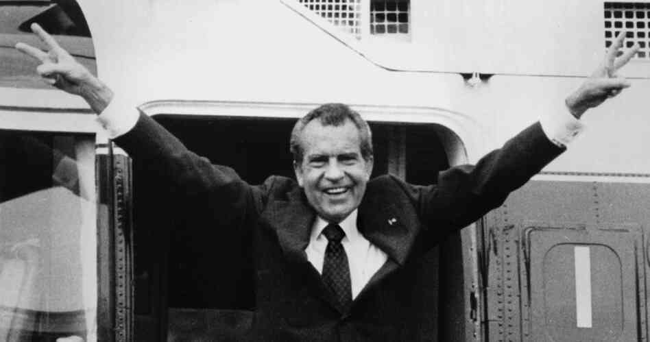 Richard Nixon says goodbye with a victorious salute to his staff members outside the White House as he boards a helicopter after resigning the presidency on Aug. 9, 1974.