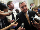 U.S. Senate Majority Whip Richard Durbin (D-IL) is surrounded by reporters at the Capitol Friday after a briefing on the debt ceiling.