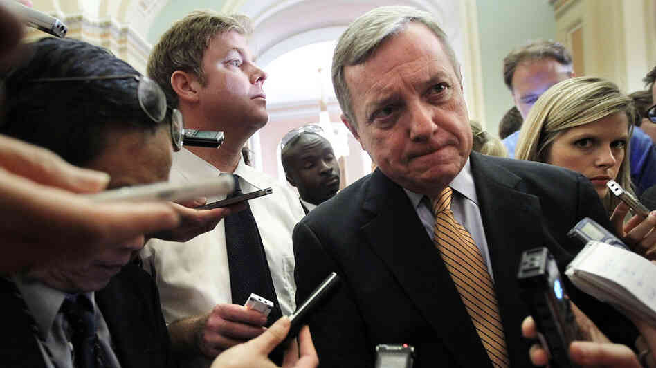 U.S. Senate Majority Whip Richard Durbin (D-IL) is surrounded by reporters at the Capitol Friday after a briefing on the debt ceiling.