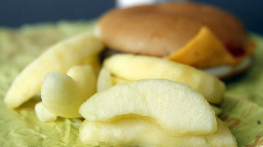 A McDonald's Cheeseburger Happy Meal with apple slices, which are becoming standard fare.