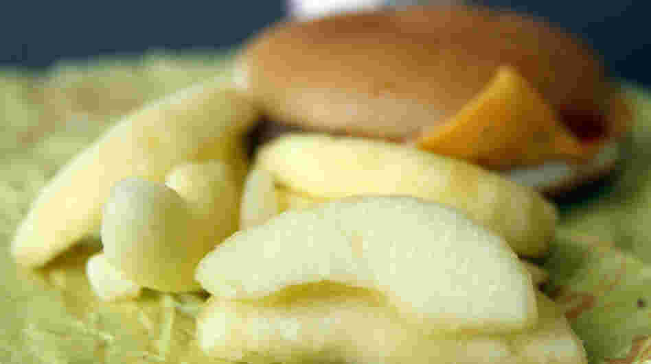 A McDonald's Cheeseburger Happy Meal with apple slices, which are becoming standard fare.