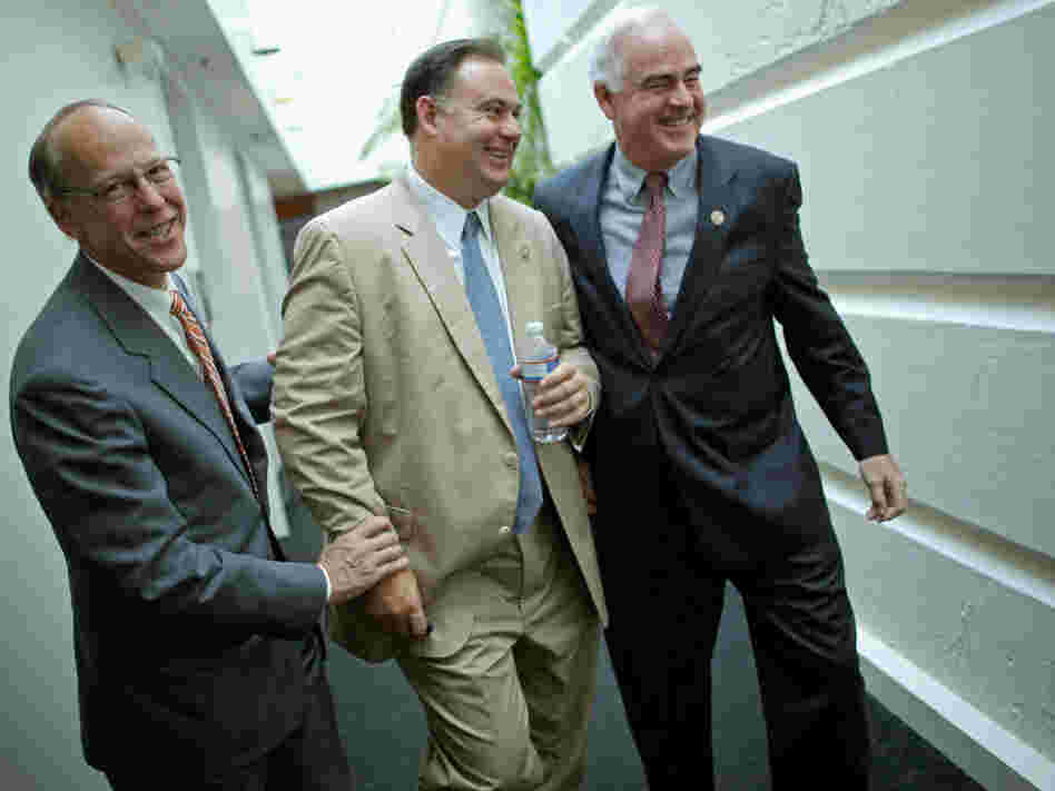 Rep. Greg Walden (R-OR) (L) and Rep. Patrick Meehan (R-PA) (R) pretend to twist the arms of Rep. Frank Guinta (R-NH), July 29. 2011.