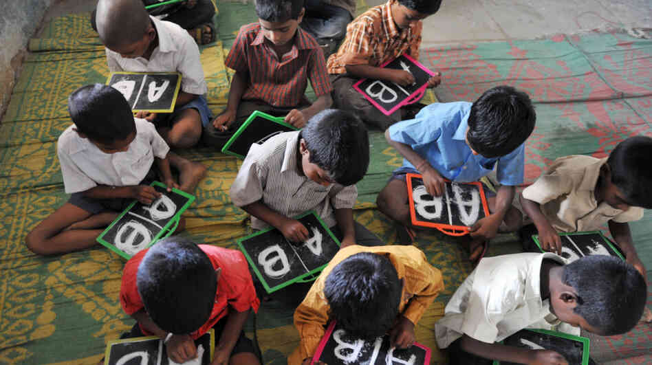 Indian schoolchildren write English alphabets on slates at a primary school outside Hyderabad in June. India is on track to overtake China as the most populous nation in just 16 years. Indian schoolchildren write English alphabets on slates at a primary school outside Hyderabad in June. India is on track to overtake China as the most populous nation in just 16 years.