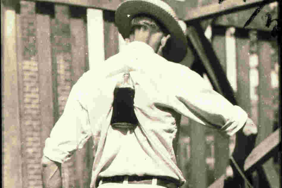 Henry Gibbs of Old Fort, N.C., lifts a whiskey bottle with his shoulder blades, 1931.