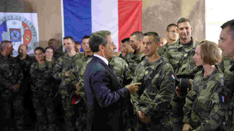 French President Nicolas Sarkozy speaks with French troops at the 152nd Infantry Regiment military base in the region of Surobi, Afghanistan, in July. Analysts say the French military has been strained by restructuring, budget cuts and simultaneous conflicts abroad.