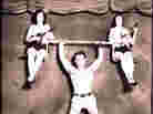 Physical instructor Charles Russell demonstrates his strength, May 18, 1939.