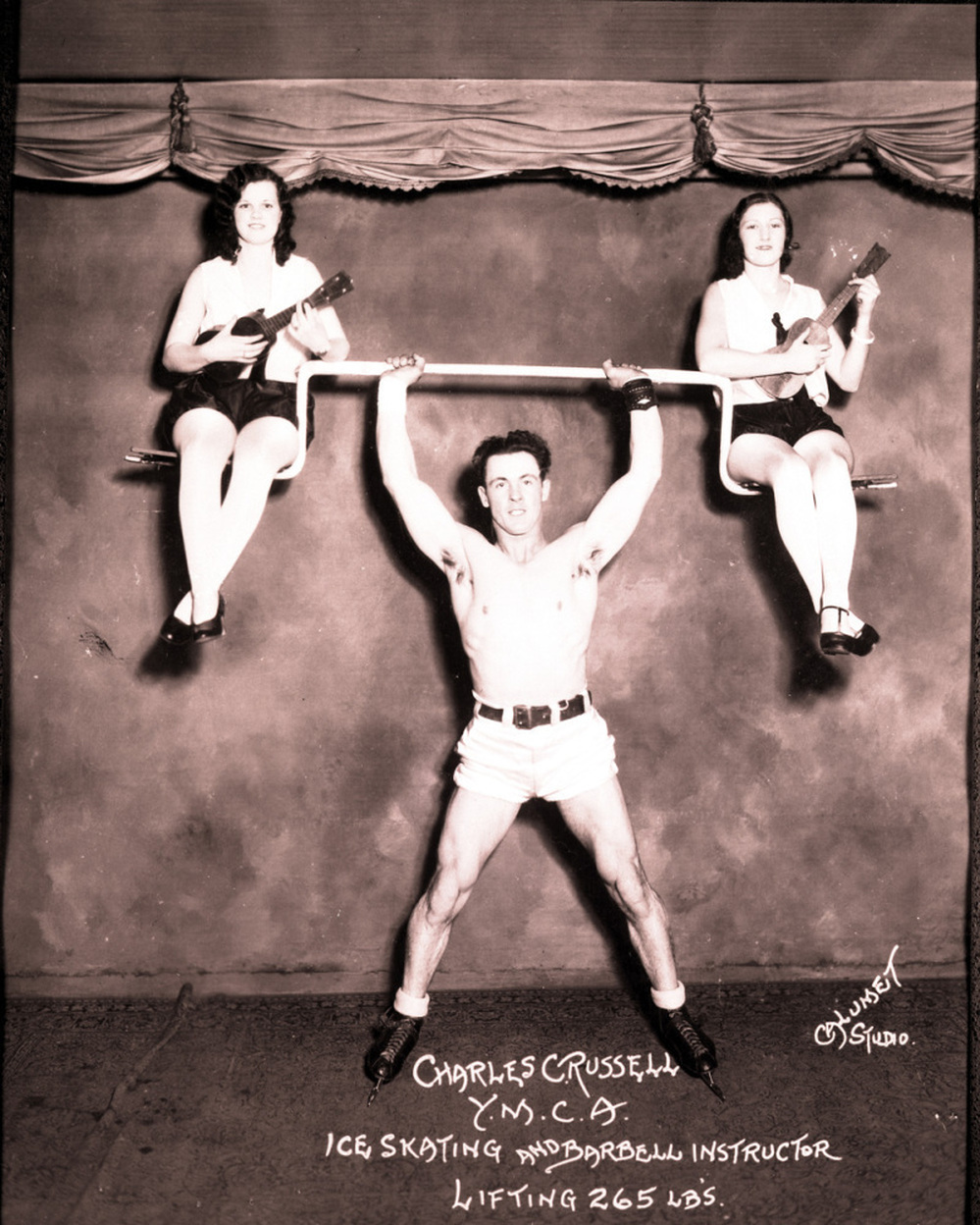 Physical instructor Charles Russell demonstrates his strength, May 18, 1939.
