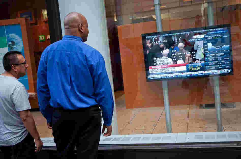 The House vote on raising the debt ceiling drew the interest of passers-by in New York. The bill will now head to the Senate, which is expected to vote on it Tuesday.