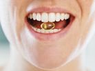 Closeup of woman holding a capsule between her teeth.. Closeup of woman holding a capsule between her teeth..
