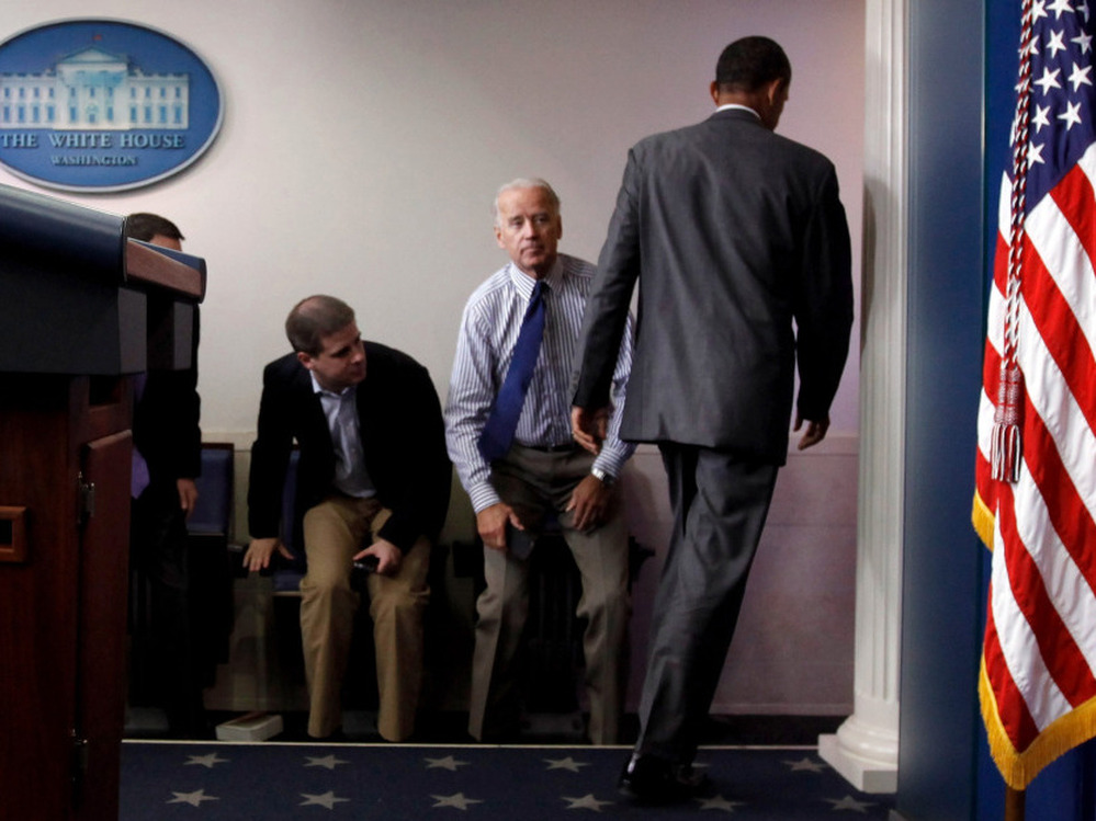 President Obama walks past Vice President Joe Biden and aide Dan Pfeiffer in the briefing room Sunday.