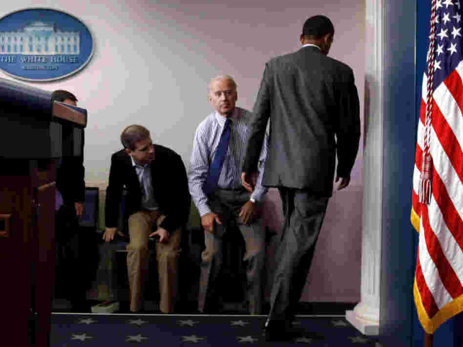 President Obama walks past Vice President Joe Biden and aide Dan Pfeiffer in the briefing room Sunday.