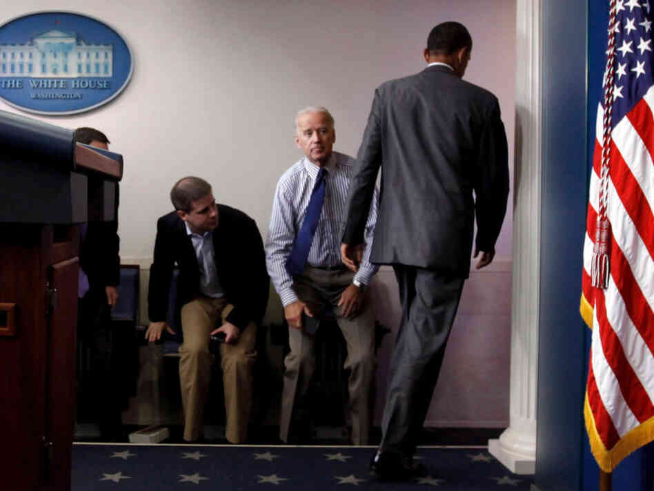 President Obama walks past Vice President Joe Biden and aide Dan Pfeiffer in the briefing room Sunday.