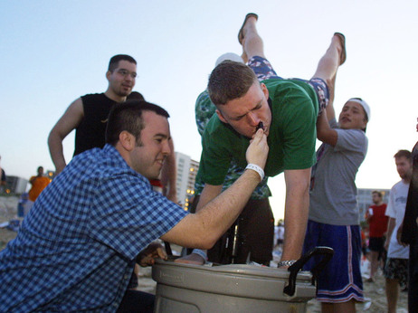 College students aid a colleague as he performs a keg stand in this file photo. Princeton Review released its new list of top party schools in America Monday. College students aid a colleague as he performs a keg stand in this file photo. Princeton Review released its new list of top party schools in America Monday.