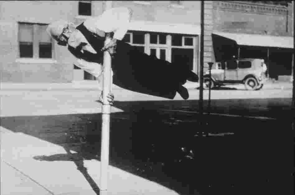 Perry L. Biddle of DeFuniack Springs, Fla., holds himself in a "human flag" position on his 90th birthday.