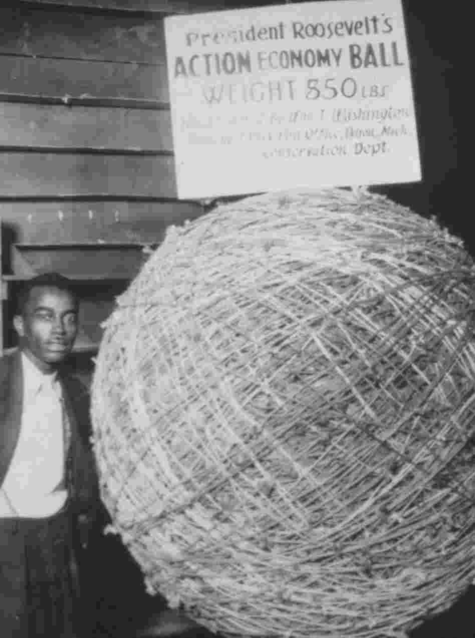William T. Washington poses with a "hand tailored," 850-pound ball of string, 1933. The ball was six feet in diameter. William T. Washington poses with a "hand tailored," 850-pound ball of string, 1933. The ball was six feet in diameter.