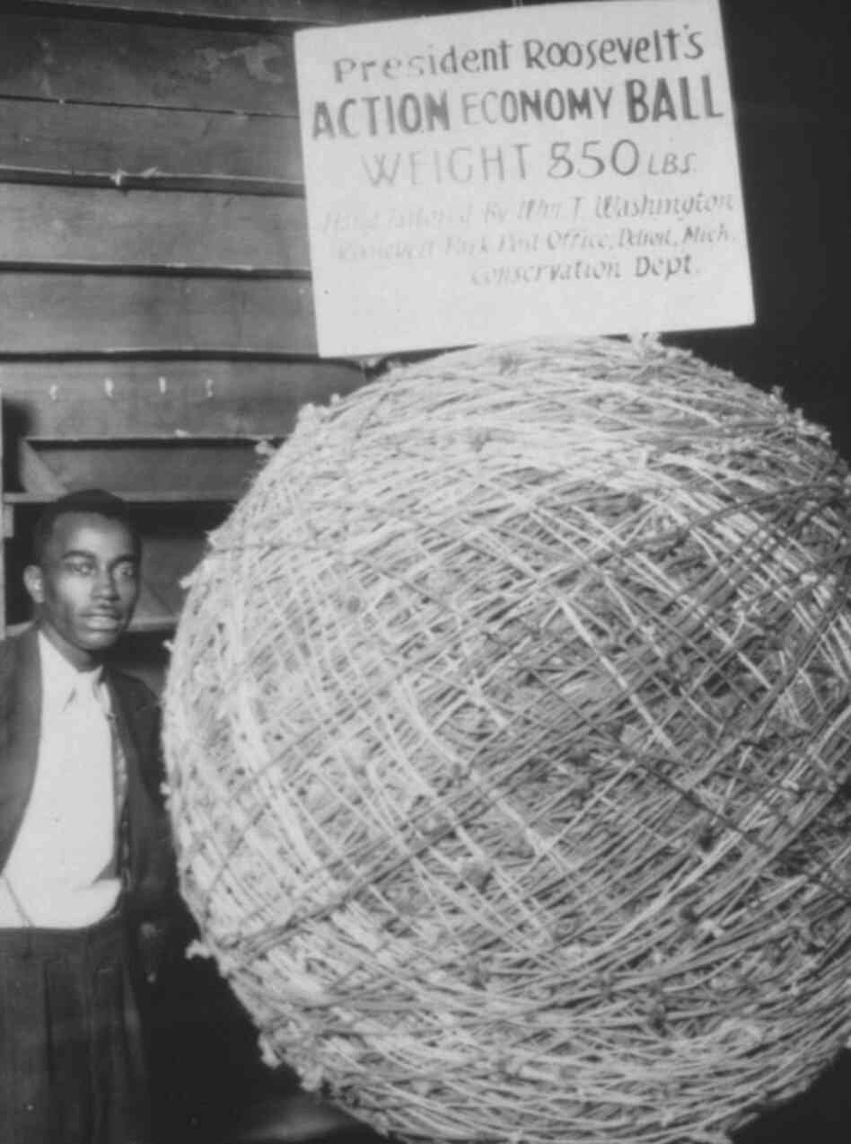William T. Washington poses with a "hand tailored," 850-pound ball of string, 1933. The ball was six feet in diameter. William T. Washington poses with a "hand tailored," 850-pound ball of string, 1933. The ball was six feet in diameter.