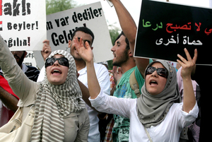 Members of a pro-Islamic human rights group hold up a sign that reads Members of a pro-Islamic human rights group hold up a sign that reads