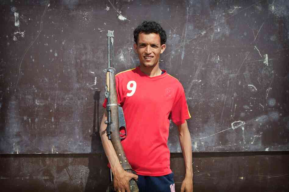 A Libyan rebel poses with his antique bolt-action rifle. He said that it was an American-made 1911; it is actually an Italian-made Carcano. That rifle was most widely used during World War II but can still be found in use in western Libya.