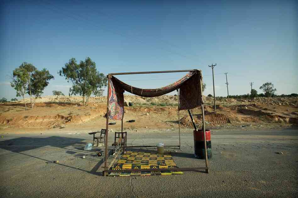 "What emerged as a running theme," says Levinson, "was the level of ingenuity ... which has survived even in the face of food shortages and the obvious hardships." Here, an improvised shelter is seen at a rebel checkpoint in the Nafusa Mountains.