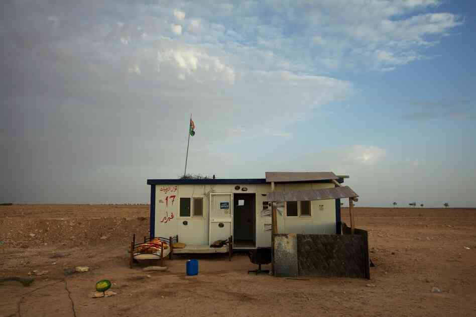 A checkpoint guards the stretch of road in Rhybat that has been turned into a makeshift airplane runway.