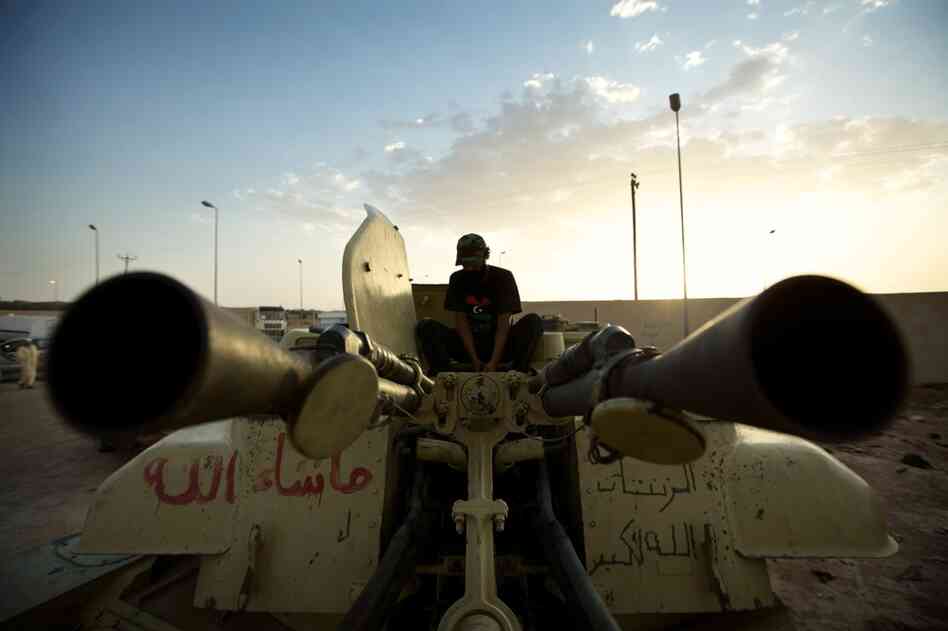 A rebel fighter loads ammunition into a ZSU-23 "Shilka" self-propelled anti-aircraft gun in Zintan.
