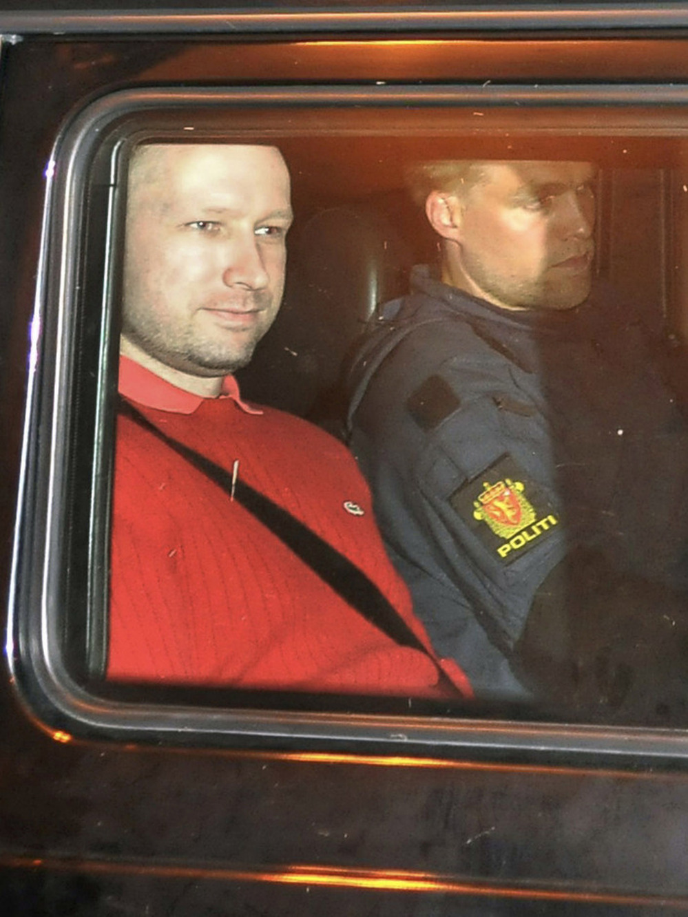 Anders Behring Breivik, left, leaves an Oslo courthouse in a police car after a hearing. Since then, Breivik has been held in solitary confinement.