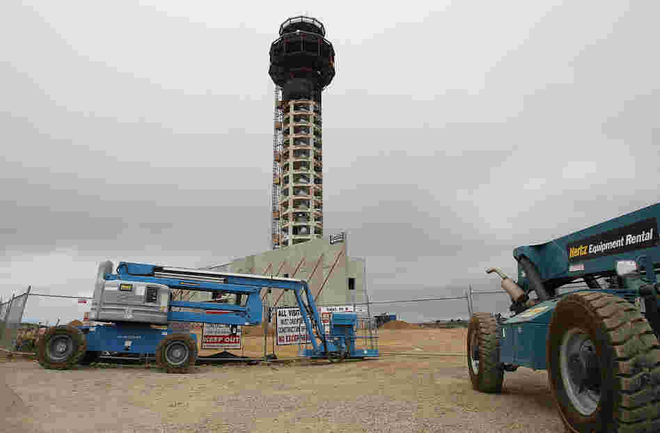 Construction equipment sits idle in front of the half-completed new control tower at Oakland International Airport. Thousands of construction workers on aviation projects have stopped work, as a standoff over funding of the FAA continues.