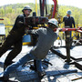 Workers move a section of well casing into place at a natural gas drilling rig near Burlington, Pa. The industry is expected to drill as many as 10,000 new wells in the next few  years.