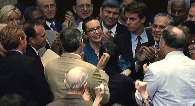 Rep. Gabrielle Giffords (D-AZ), center, is welcomed by her fellow members of the the House of Representatives as she appears on the floor for the first time since her shooting earlier this year.