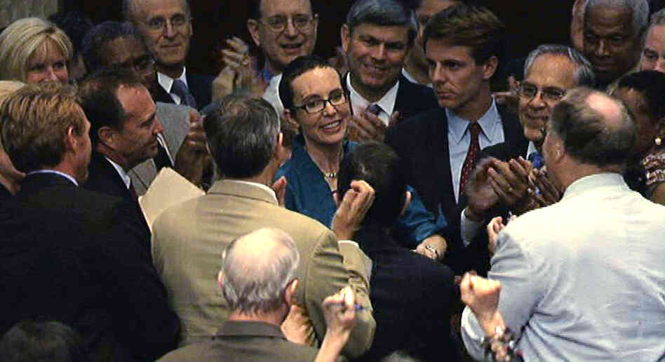 Rep. Gabrielle Giffords (D-AZ), center, is welcomed by her fellow members of the the House of Representatives as she appears on the floor for the first time since her shooting earlier this year.