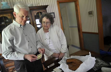 Jeffrey Quick, 69, holds a family photo of his parents and Lou Gehrig's mother as he and his wife, Joan, stand in their dining room. On the table next to them is a glove signed by Gehrig's Yankees teammates - a gift from Christina Gehrig. Jeffrey Quick, 69, holds a family photo of his parents and Lou Gehrig's mother as he and his wife, Joan, stand in their dining room. On the table next to them is a glove signed by Gehrig's Yankees teammates - a gift from Christina Gehrig.