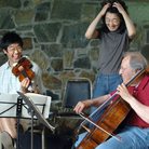 Violinist Soovin Kim, pianist Mitsuko Uchida and cellist David Soyer caught in a light moment at the Marlboro Music Festival Violinist Soovin Kim, pianist Mitsuko Uchida and cellist David Soyer caught in a light moment at the Marlboro Music Festival