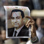 A protester holds a defaced poster of Egypt's then-President Hosni Mubarak, with the words A protester holds a defaced poster of Egypt's then-President Hosni Mubarak, with the words